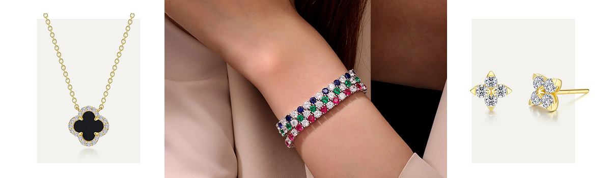 A chic girl sporting a stacked wrist with three sparkly alternating gemstone & diamond tennis bracelets with emeralds, sapphires, and rubies.