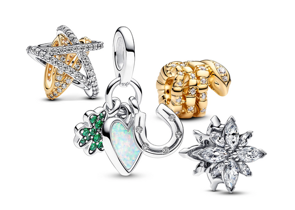 A collection of cubic zirconia Pandora Charms featuring a gold-plated curled snake charm, a sparkling mixed-metal crossover star charm, and four leaf clover, heart/ horseshoe triple dangle charm.