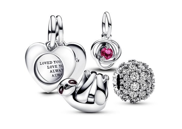 A collection of sterling sIlver Pandora Charms, including engravable heart magnifying glass double dangle charm, hanging sloth charm, a pink eternity circle dangle charm, and sparkling pavé round charm.