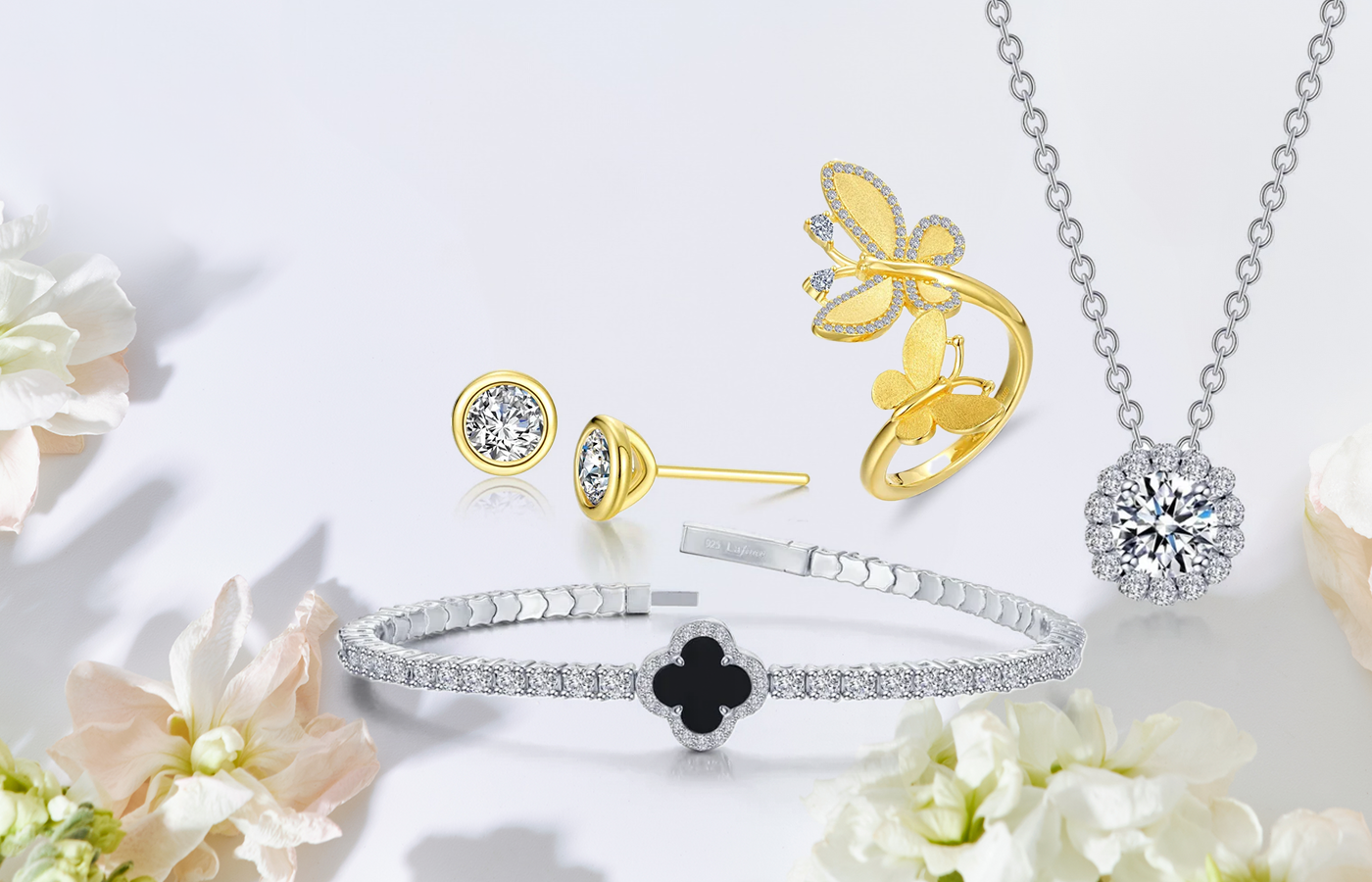 Sparkling Lassaire TR gold Butterfly ring, onyx and diamond clover flexi bangle, and 1.05 CTW Round Halo Necklace displayed elegantly.