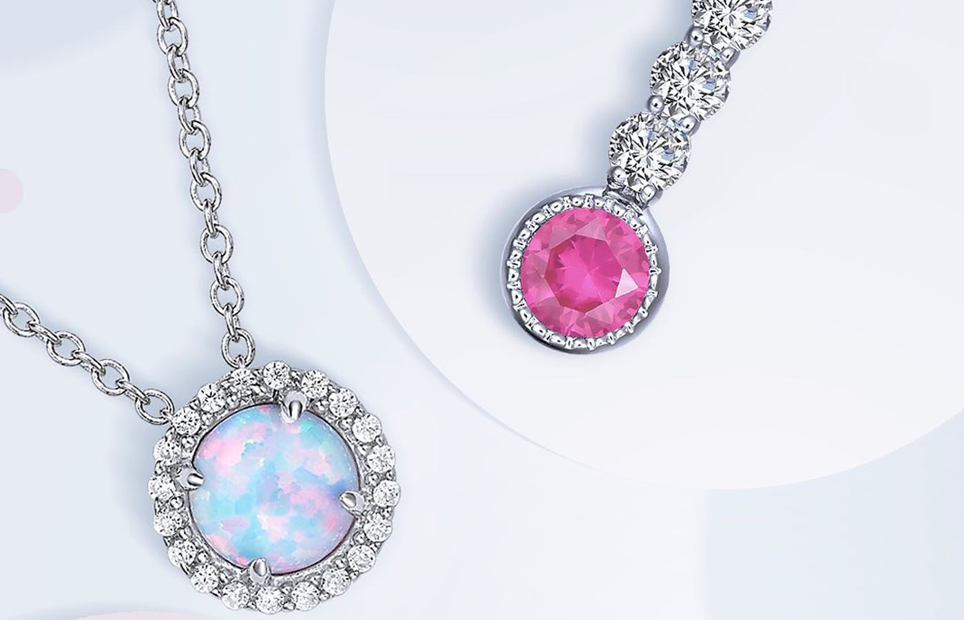 Lustrous opal and Lassaire simulated diamond necklace next to a vibrant pink birthstone charm pendant.