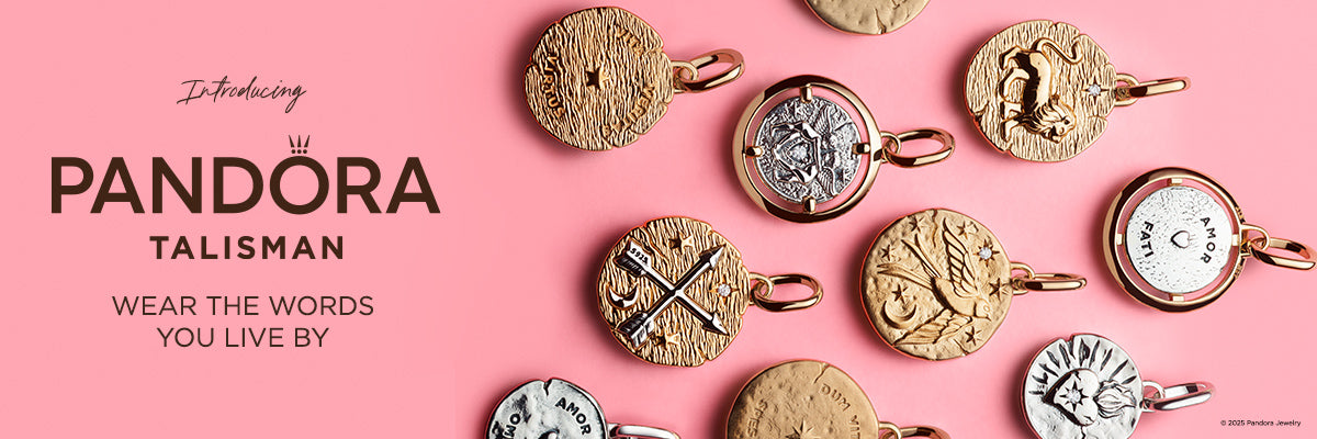 Pandora Talisman Collection featuring an assortment of gold and silver coin-shaped pendants with celestial, symbolic, and engraved designs, displayed on a pink background with the tagline “Wear the Words You Live By.”